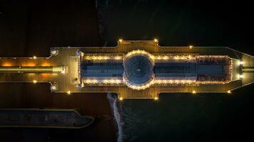 Aerial view of Brighton pier at night with all the colours coming out, East Sussex, UK photo