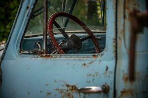 Classic, vintage truck, rat rod, with paint pealing off at the garage photo