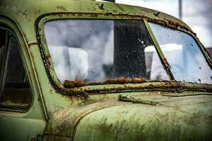 Classic, vintage truck, rat rod, with paint pealing off at the garage photo