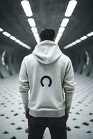 Back view of man in white hoodie while standing in underground tunnel photo