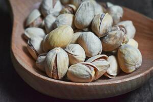 Pistachio on wooden background photo