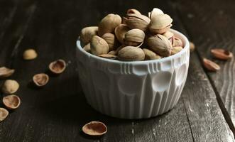 Pistachio on wooden background photo