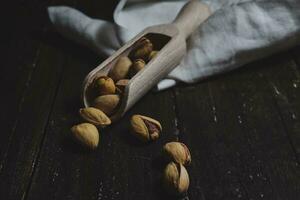 Pistachio on wooden background photo