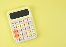 flat lay of colorful  calculator on yellow  background with copy space. photo