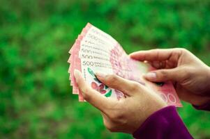 people counting banknotes, Nicaraguan 500 cordobas banknotes photo