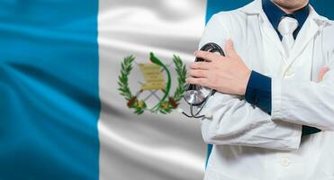 Doctor with stethoscope on guatemalan flag. Doctor arms crossed with stethoscope on Guatemalan flag, Guatemala national health concept photo