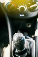 Close up of a car gear knob. Detail view of a vehicle transmission lever, Gear lever of a vehicle. Close-up of a car gear lever photo