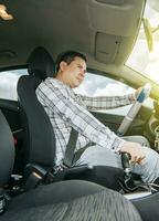 Interior view of a young man driving a car, A happy man driving a car, Side view of a man driving a car, concept of man brand new car photo