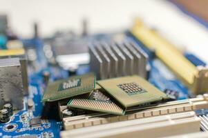 Close up of a motherboard, details of a computer motherboard, detail of a motherboard socket, three processors on a computer motherboard photo