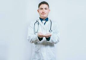 Hands of young doctor presenting something empty-handed. Doctor with hands together and empty. Doctor holding something in his hands isolated photo