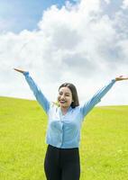 Smiling young woman spreading her arms in the field, concept of free woman spreading her hands, Attractive girl spreading her arms in the field photo