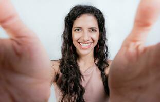 Happy girl taking a selfie looking at the camera isolated. Smiling young woman taking a self portrait isolated. photo