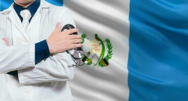 Doctor with stethoscope on guatemalan flag. Doctor arms crossed with stethoscope on Guatemalan flag, Guatemala national health concept photo