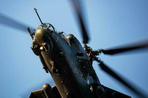 Hungarian Air Force Mil Mi-24 Hind military attack helicopter. Flight operation. Aviation industry and rotorcraft. Transport and airlift. Fly and flying. photo