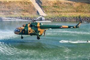 Hungarian Air Force Mil Mi-17 military transport helicopter. Flight operation and airlift. Aviation industry and rotorcraft. Fly and flying. photo