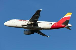 Iberia Airlines Airbus A319 passenger plane at airport. Aviation and aircraft. Air transport and travel. International transportation. Fly and flying. photo