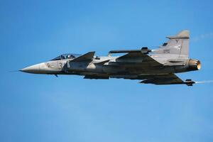 Hungarian Air Force SAAB JAS 39 Gripen. Military fighter jet plane at air base. Flight operation. Aviation and aircraft. Air defense. Fly and flying. photo