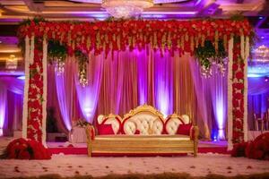 an indian wedding stage decorated with red and gold flowers. AI-Generated photo