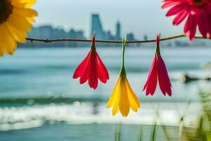 three colorful flowers hanging from a branch near the water. AI-Generated photo