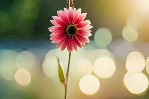 a pink flower is hanging from a string. AI-Generated photo