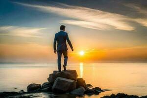 un hombre en un traje soportes en un rock en frente de el Oceano a puesta de sol. generado por ai foto