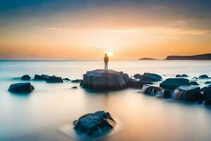 un hombre en pie en rocas en el Oceano a puesta de sol. generado por ai foto