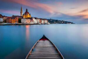 a boat is docked in front of a town at sunset. AI-Generated photo