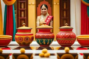 a woman in traditional indian dress sits in front of colorful pots. AI-Generated photo