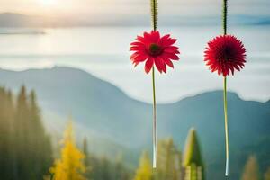 two red flowers hanging from a string in front of a mountain. AI-Generated photo