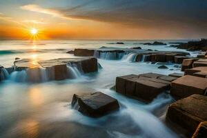 the sun sets over the ocean and rocks in the foreground. AI-Generated photo
