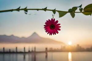a pink flower is hanging from a branch over a body of water. AI-Generated photo