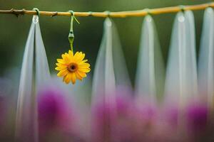 a yellow flower hanging from a string. AI-Generated photo