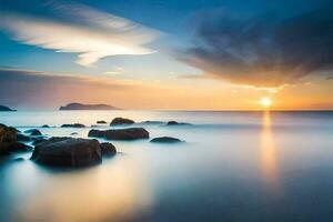a beautiful sunset over the ocean with rocks and water. AI-Generated photo