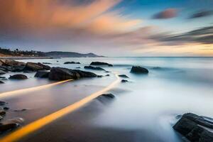 un largo exposición fotografía de rocas y agua a puesta de sol. generado por ai foto