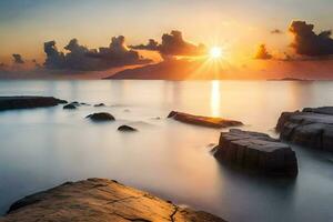 the sun rises over the ocean and rocks. AI-Generated photo