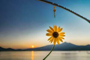 a single yellow sunflower is hanging from a fishing pole. AI-Generated photo