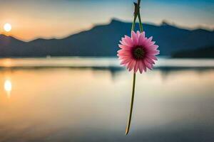 a pink flower is hanging from a branch over a lake. AI-Generated photo