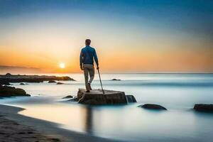 a man standing on a rock at the beach at sunset. AI-Generated photo