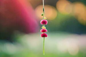 a pink flower hanging from a string. AI-Generated photo