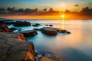 the sun rises over the ocean and rocks in the foreground. AI-Generated photo