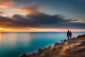 a couple standing on the edge of a cliff overlooking the ocean at sunset. AI-Generated photo