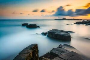 un largo exposición fotografía de rocas en el Oceano a puesta de sol. generado por ai foto