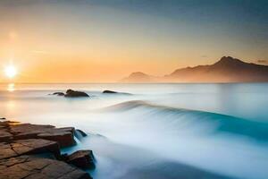 a beautiful sunset over the ocean with rocks and water. AI-Generated photo