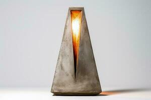 Contemporary concrete table lamp with a subtle glow isolated on a white background photo