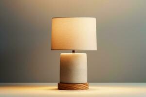 Contemporary concrete table lamp exuding soft light isolated on a gradient background photo