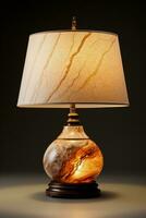 Chic marble base table lamp emitting subtle glow isolated on a gradient background photo