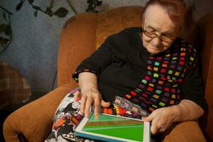 Senior woman surfing the internet on a tablet photo