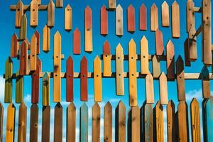 colorful wooden fence with blue sky background. AI-Generated photo