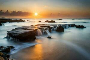 the sun rises over the ocean and rocks in the water. AI-Generated photo