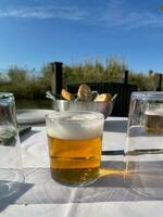 Glass of beer on the cafe table photo